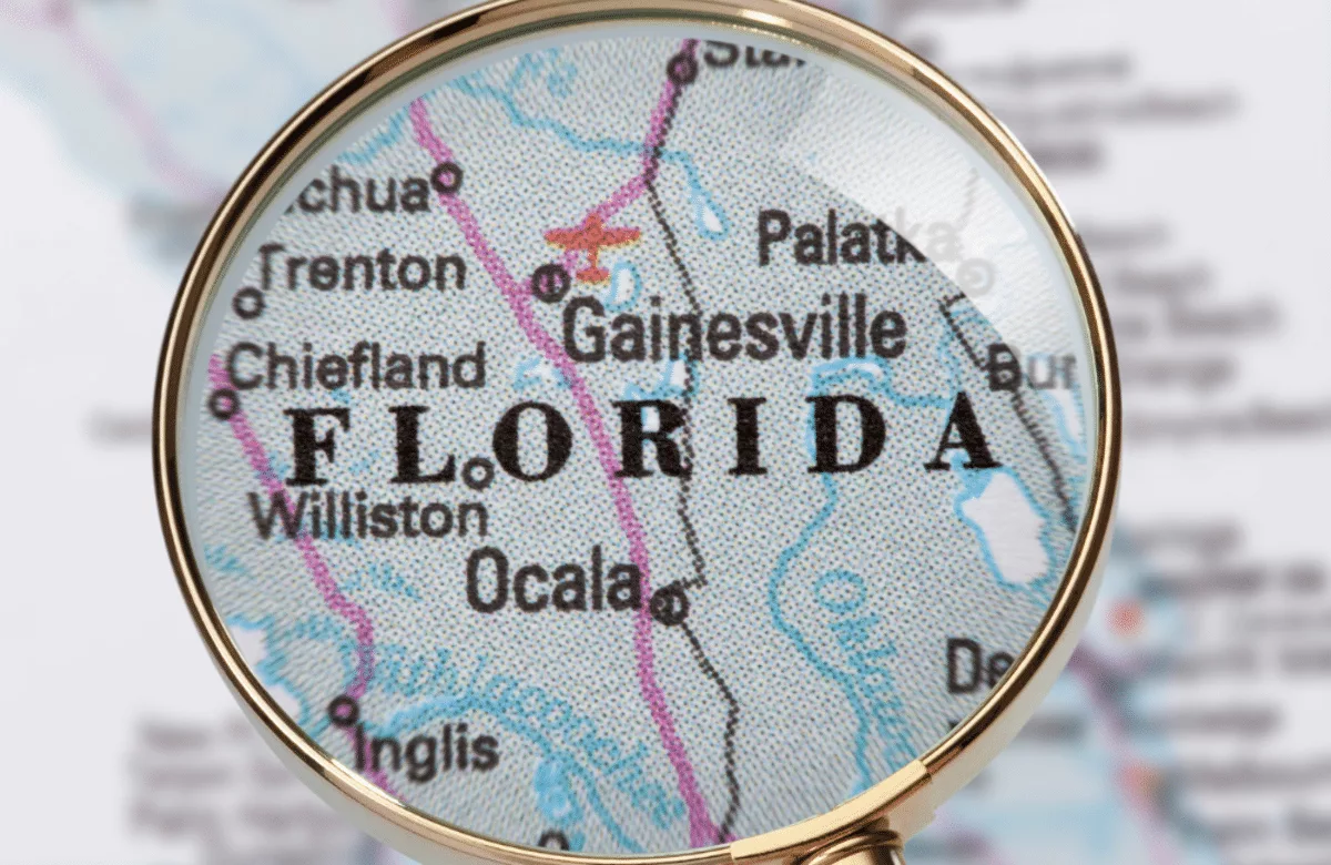 Map of Florida with Gainesville highlighted under a magnifying glass.