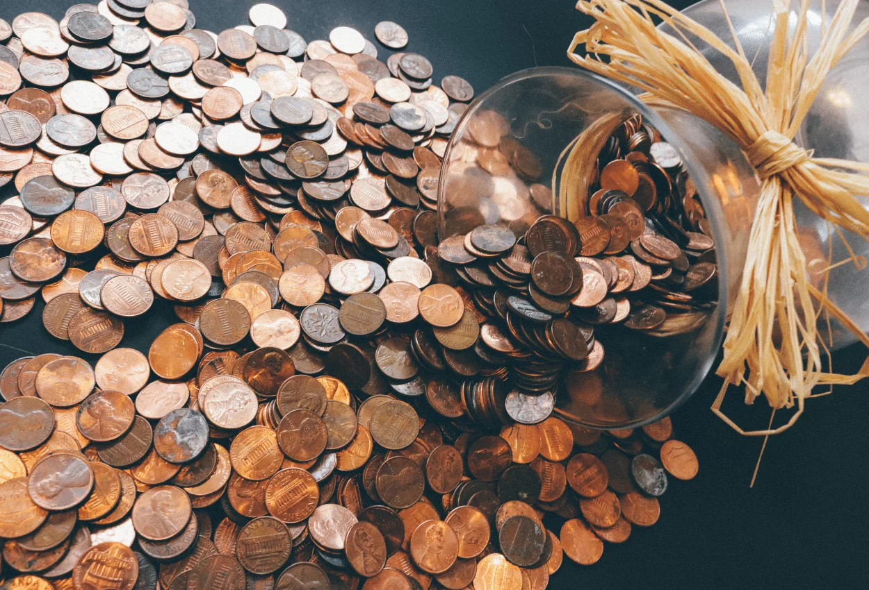 Jar of pennies spilling over for budget management.