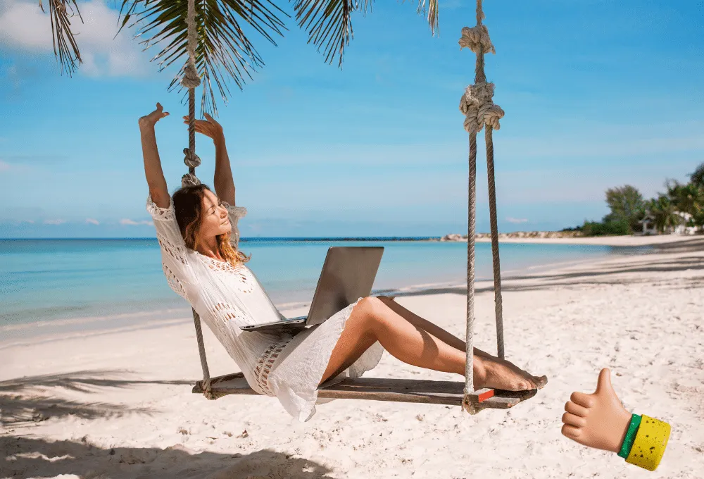 Woman working on a beach swing with a laptop, enjoying a tropical beach view.
